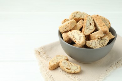 Traditional Italian almond biscuits (Cantucci) in bowl on white table. Space for text