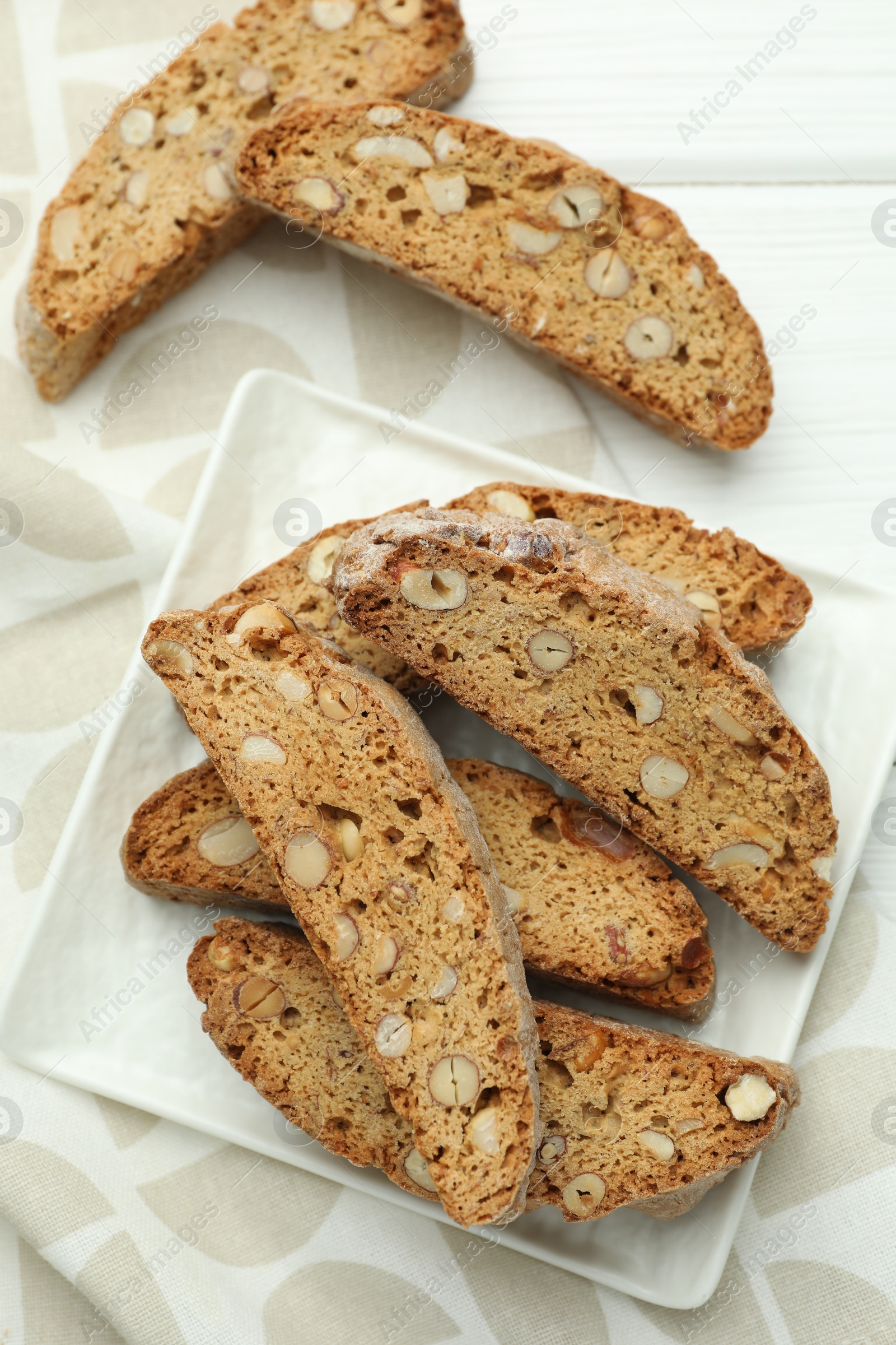 Photo of Traditional Italian almond biscuits (Cantucci) on white wooden table, top view