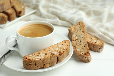 Photo of Traditional Italian almond biscuits (Cantucci) and coffee on white wooden table, closeup