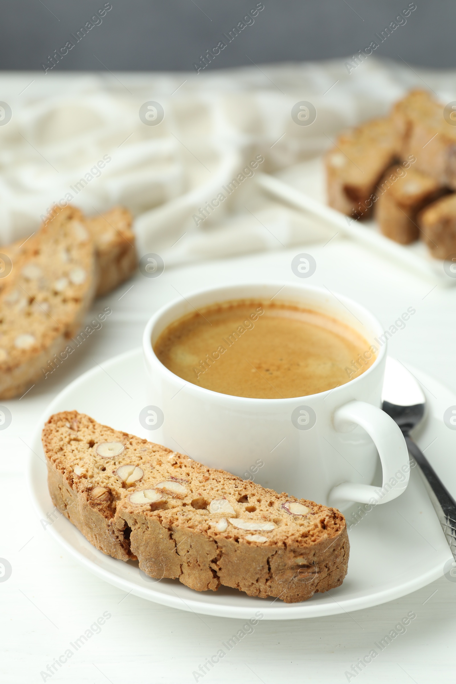 Photo of Traditional Italian almond biscuits (Cantucci) and coffee on white table, closeup