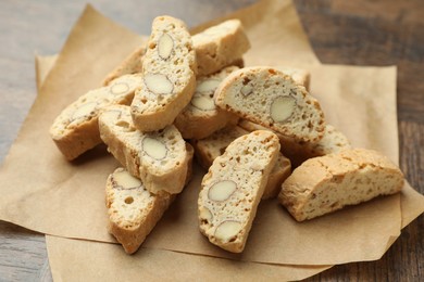 Traditional Italian almond biscuits (Cantucci) and nuts on wooden table, closeup