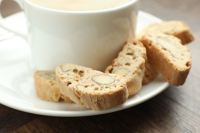 Photo of Traditional Italian almond biscuits (Cantucci) and coffee on table, closeup