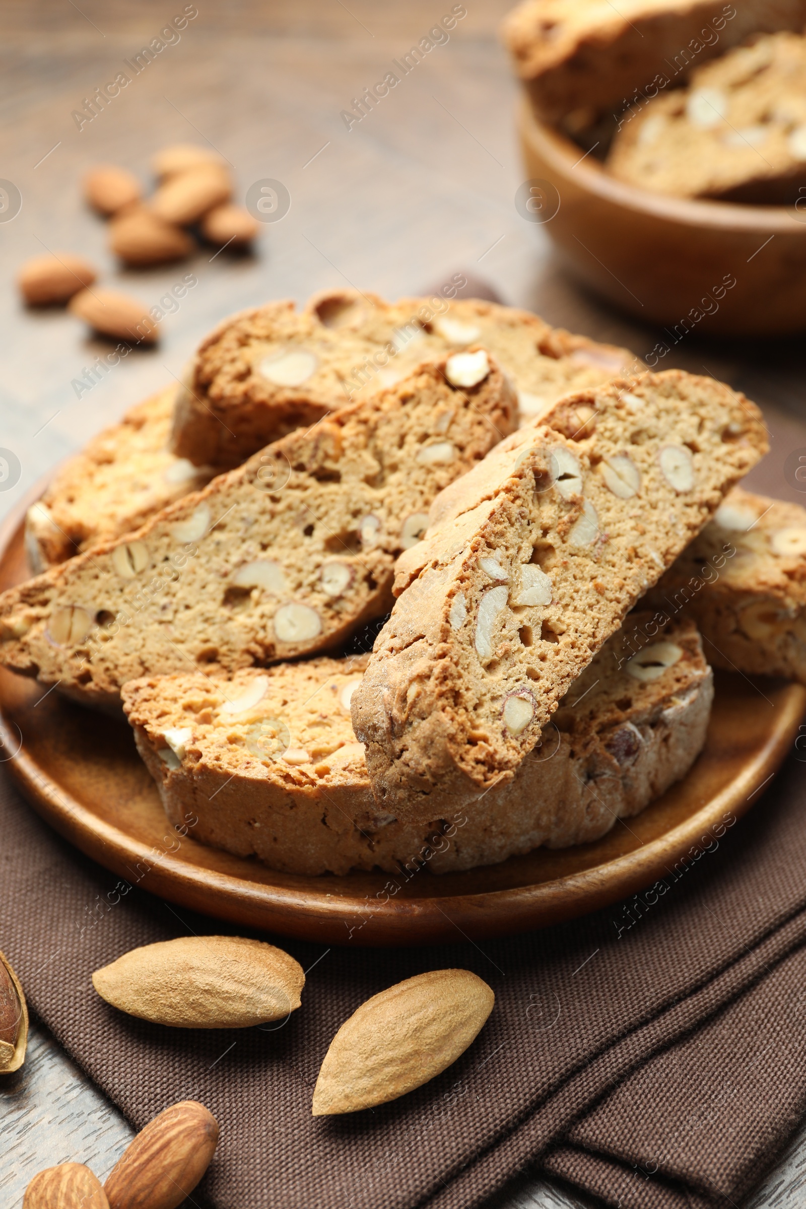 Photo of Traditional Italian almond biscuits (Cantucci) and nuts on table, closeup