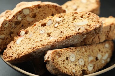 Photo of Traditional Italian almond biscuits (Cantucci) in bowl on table, closeup