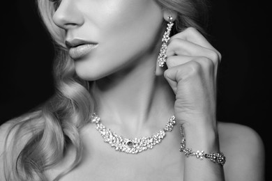 Image of Beautiful young woman with luxury jewelry, closeup. Black-and-white photo