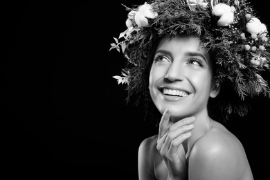 Black-and-white portrait of beautiful young woman with floral wreath