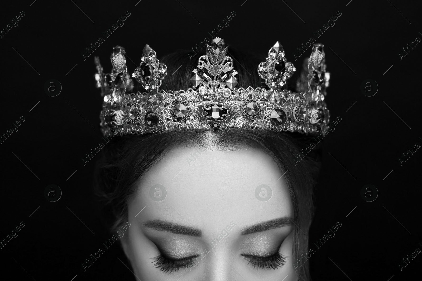 Image of Beautiful young woman with luxury crown, closeup. Black-and-white photo