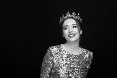 Black-and-white portrait of beautiful young woman with luxury crown