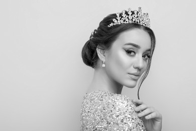 Black-and-white portrait of beautiful young woman with luxury crown