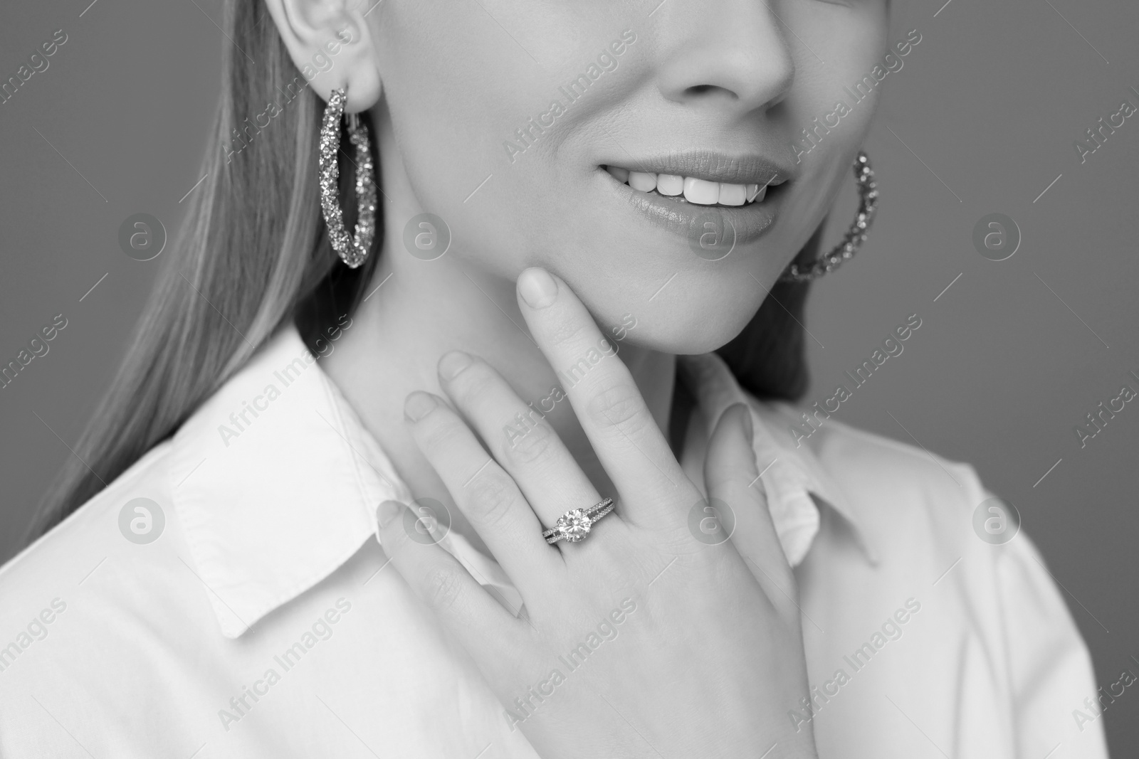 Image of Beautiful young woman with luxury jewelry, closeup. Black-and-white photo