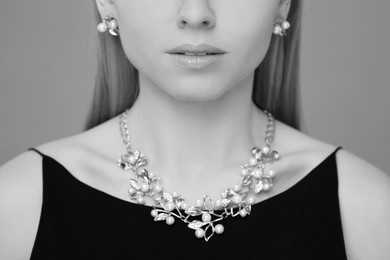 Image of Beautiful young woman with luxury jewelry, closeup. Black-and-white photo