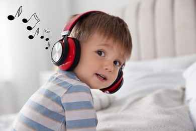 Cute little baby in headphones at home. Music notes flying near child