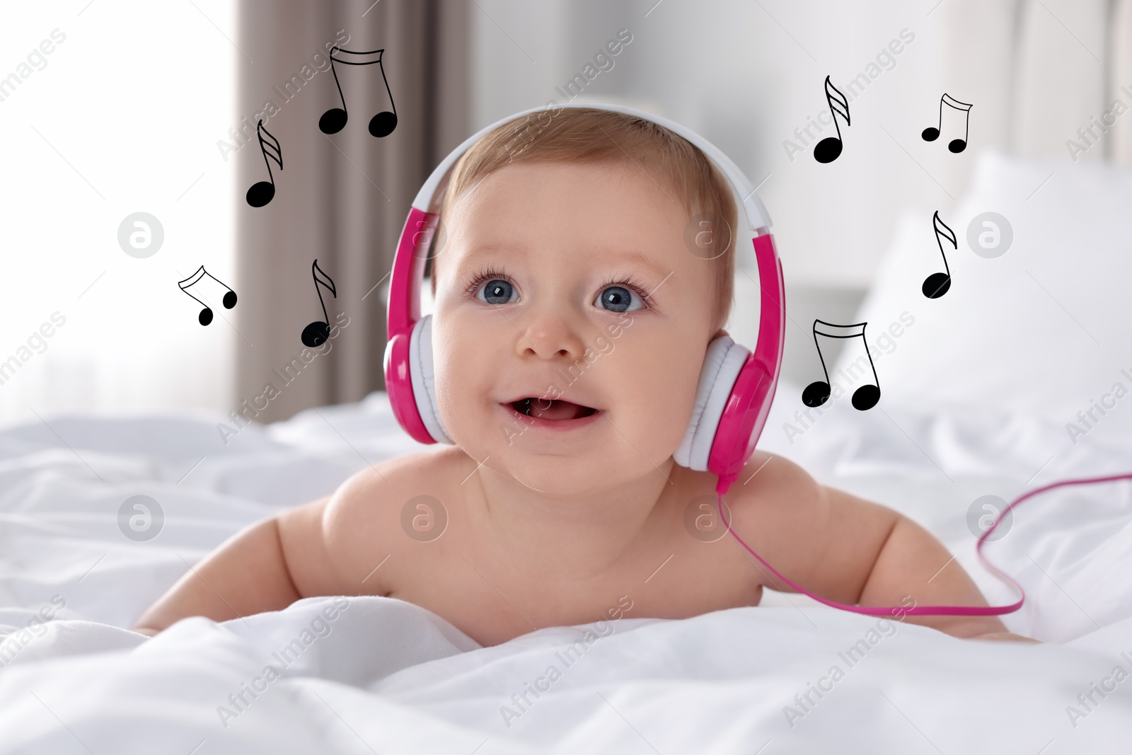 Image of Cute little baby with headphones on bed at home. Music notes flying near child