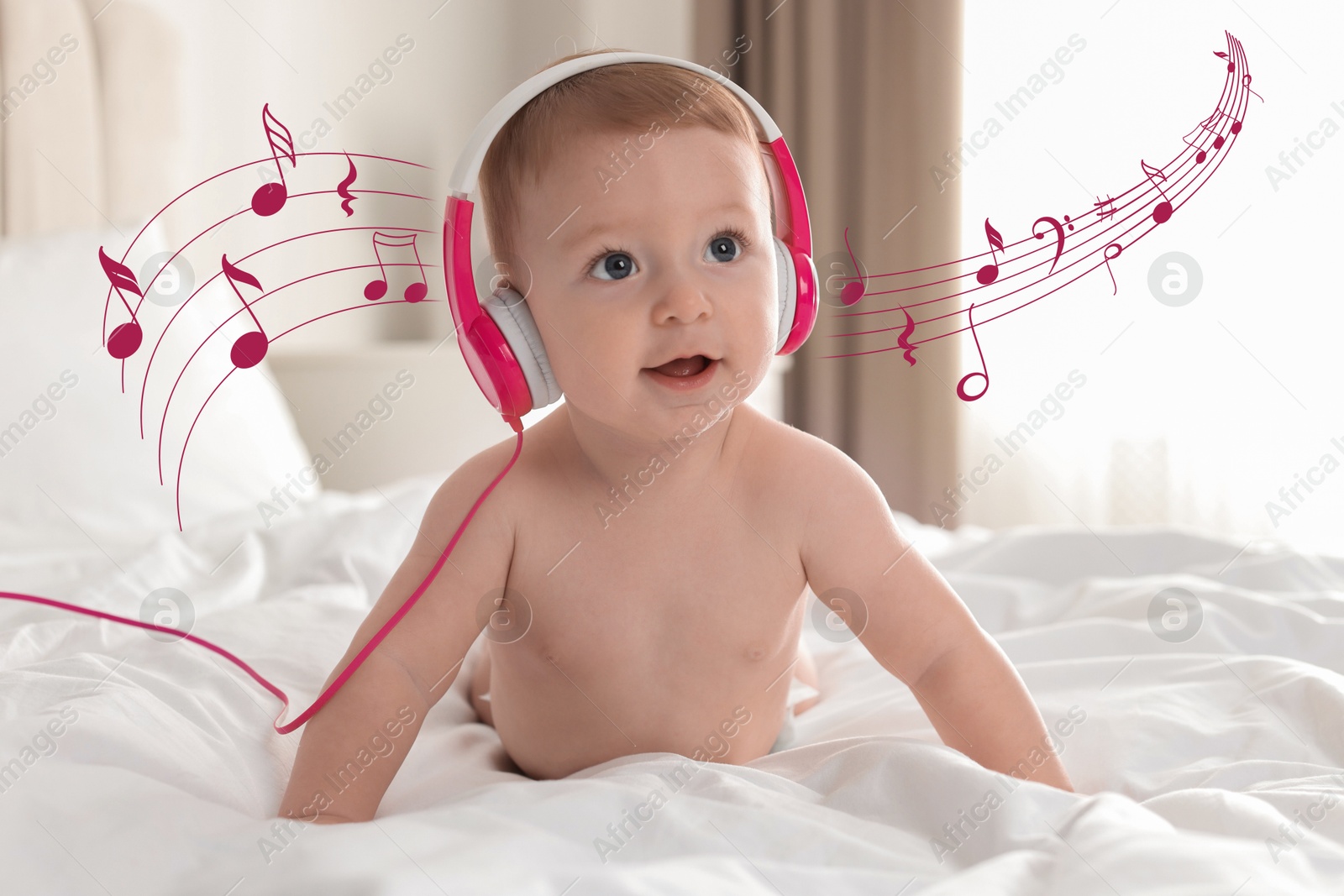 Image of Cute little baby with headphones on bed at home. Music notes flying near child