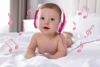 Cute little baby with headphones on bed at home. Music notes flying near child