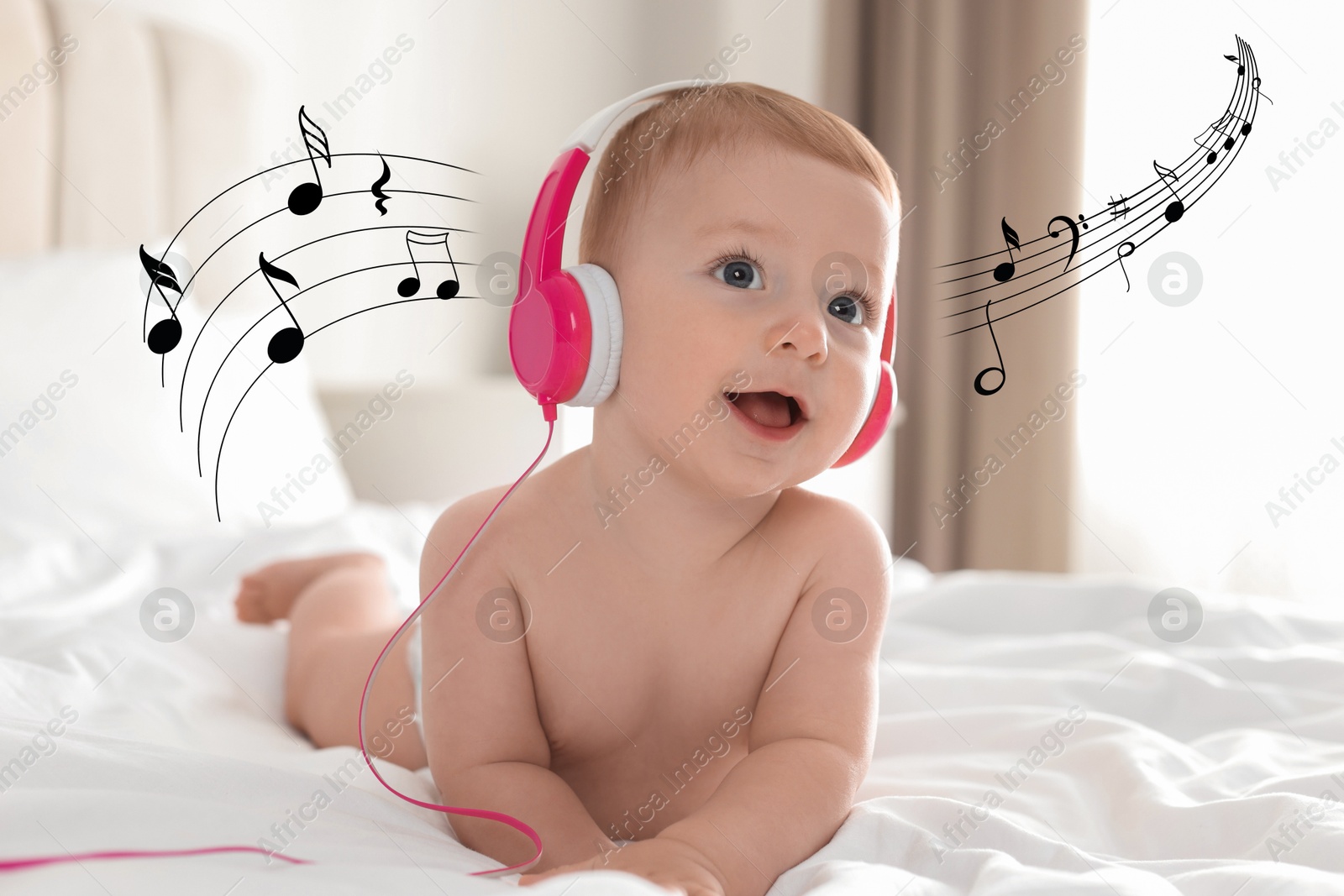 Image of Cute little baby with headphones on bed at home. Music notes flying near child