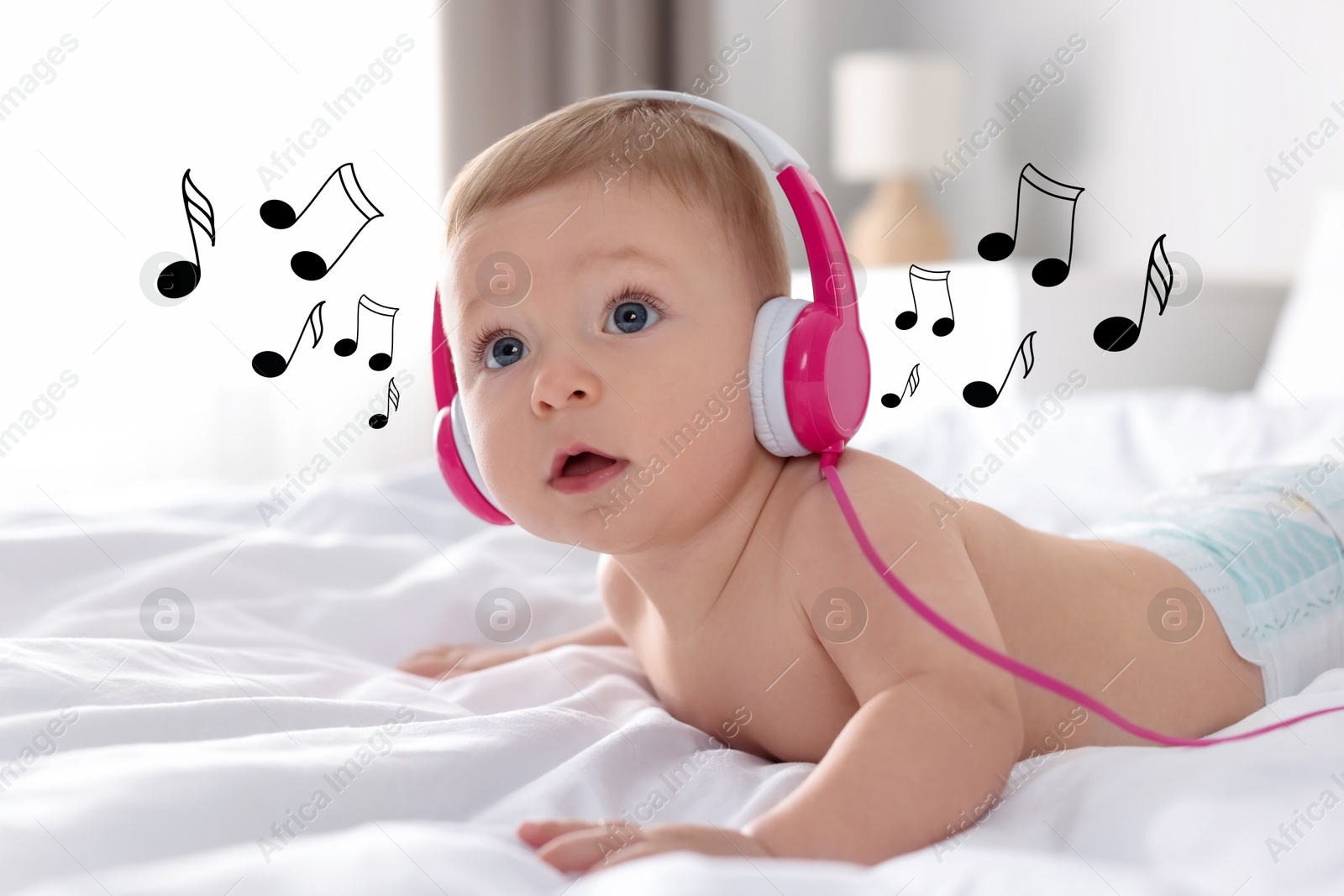 Image of Cute little baby with headphones on bed at home. Music notes flying near child