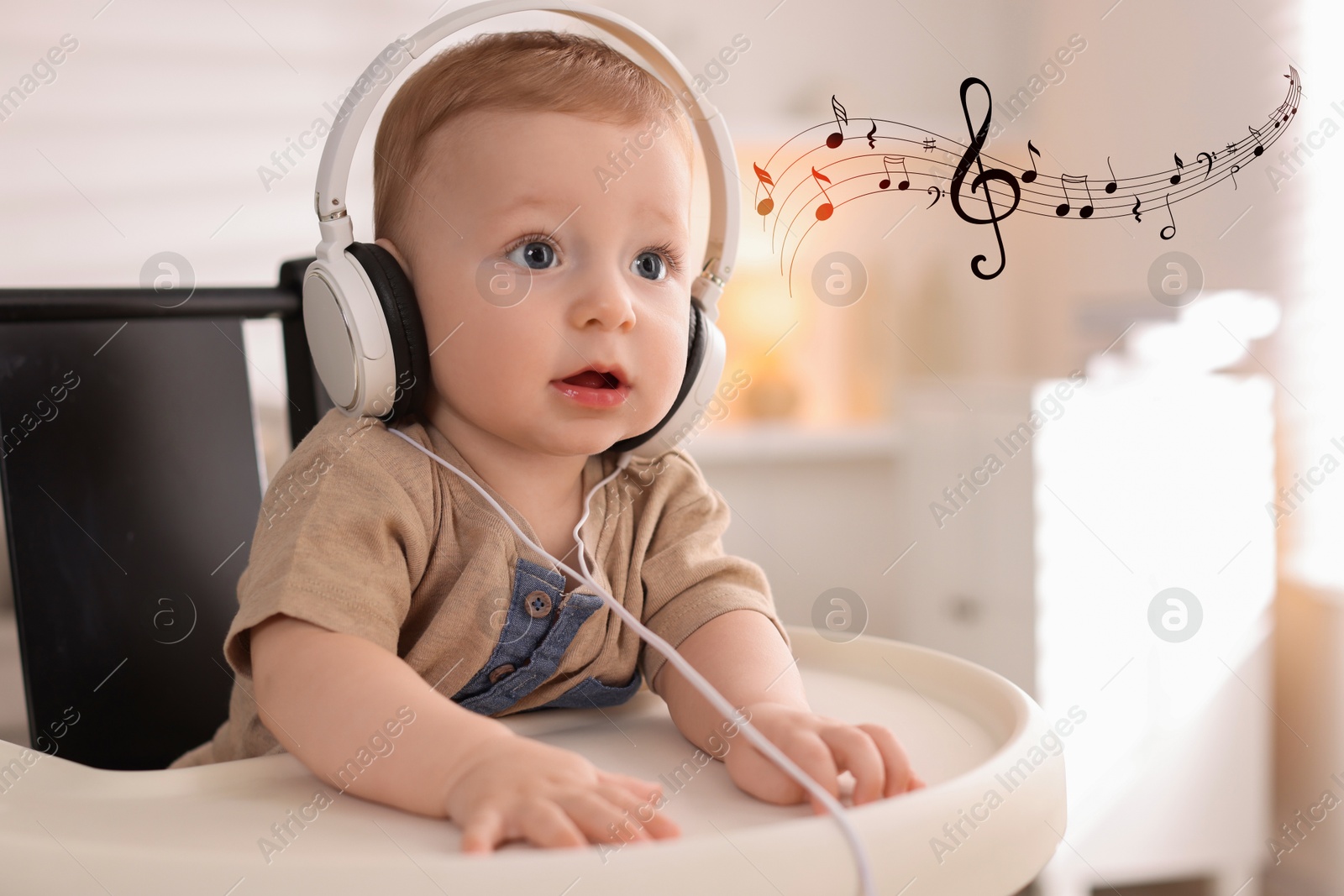 Image of Cute little baby with headphones on high chair at home. Music notes flying near child