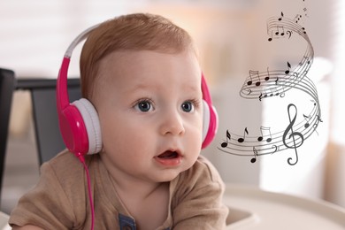 Image of Cute little baby with headphones on high chair at home. Music notes flying near child