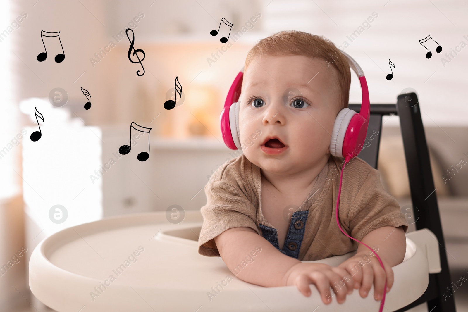 Image of Cute little baby with headphones on high chair at home. Music notes flying near child