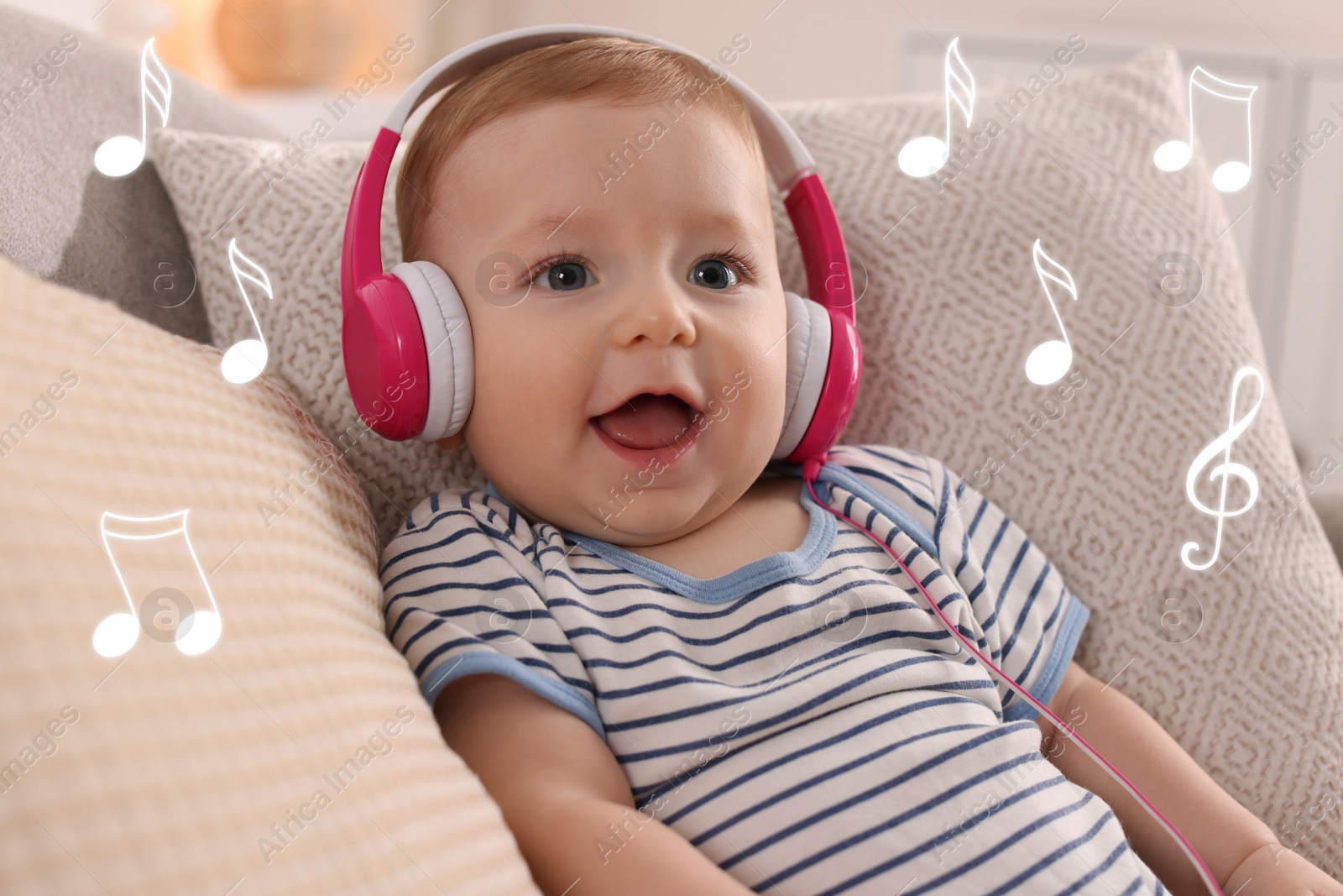 Image of Cute little baby with headphones on sofa at home. Music notes flying near child