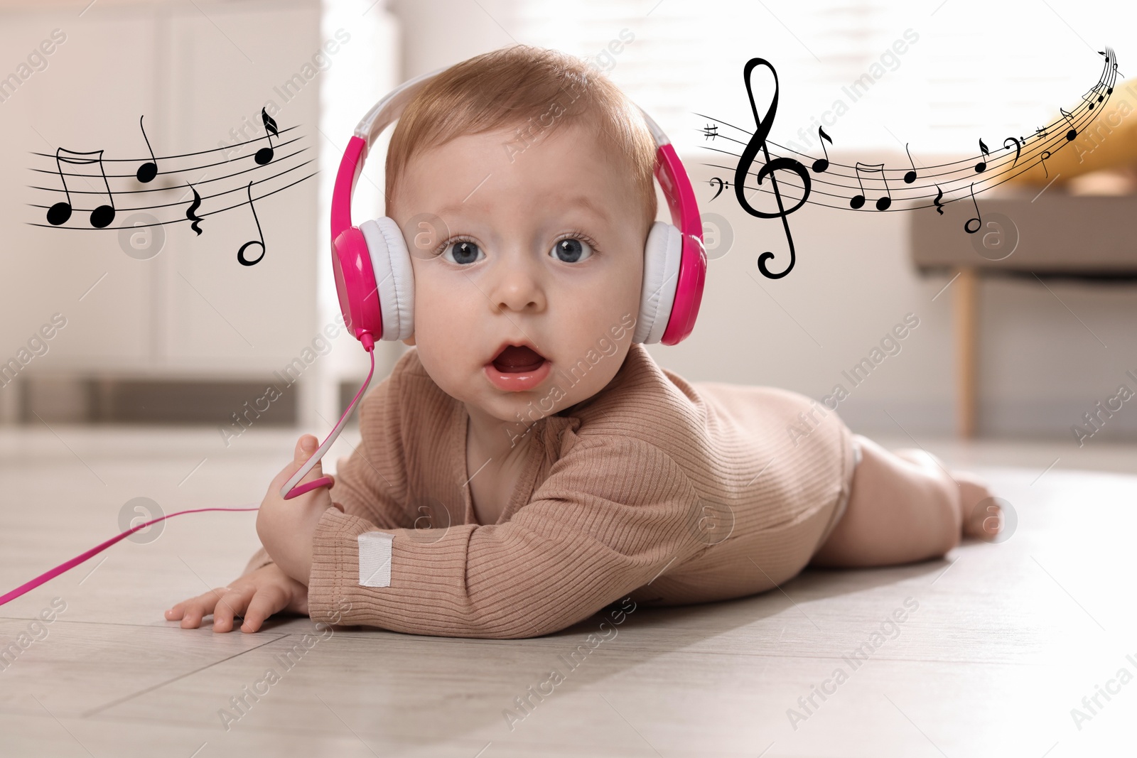 Image of Cute little baby with headphones on floor at home. Music notes flying near child