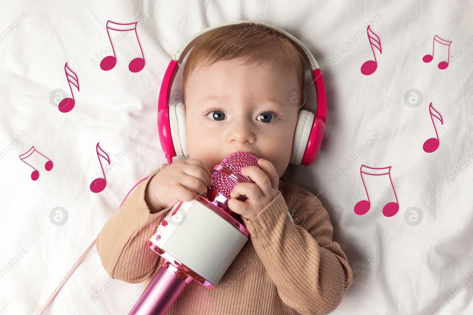 Image of Cute little baby with headphones and microphone lying on bed, top view. Music notes flying near child