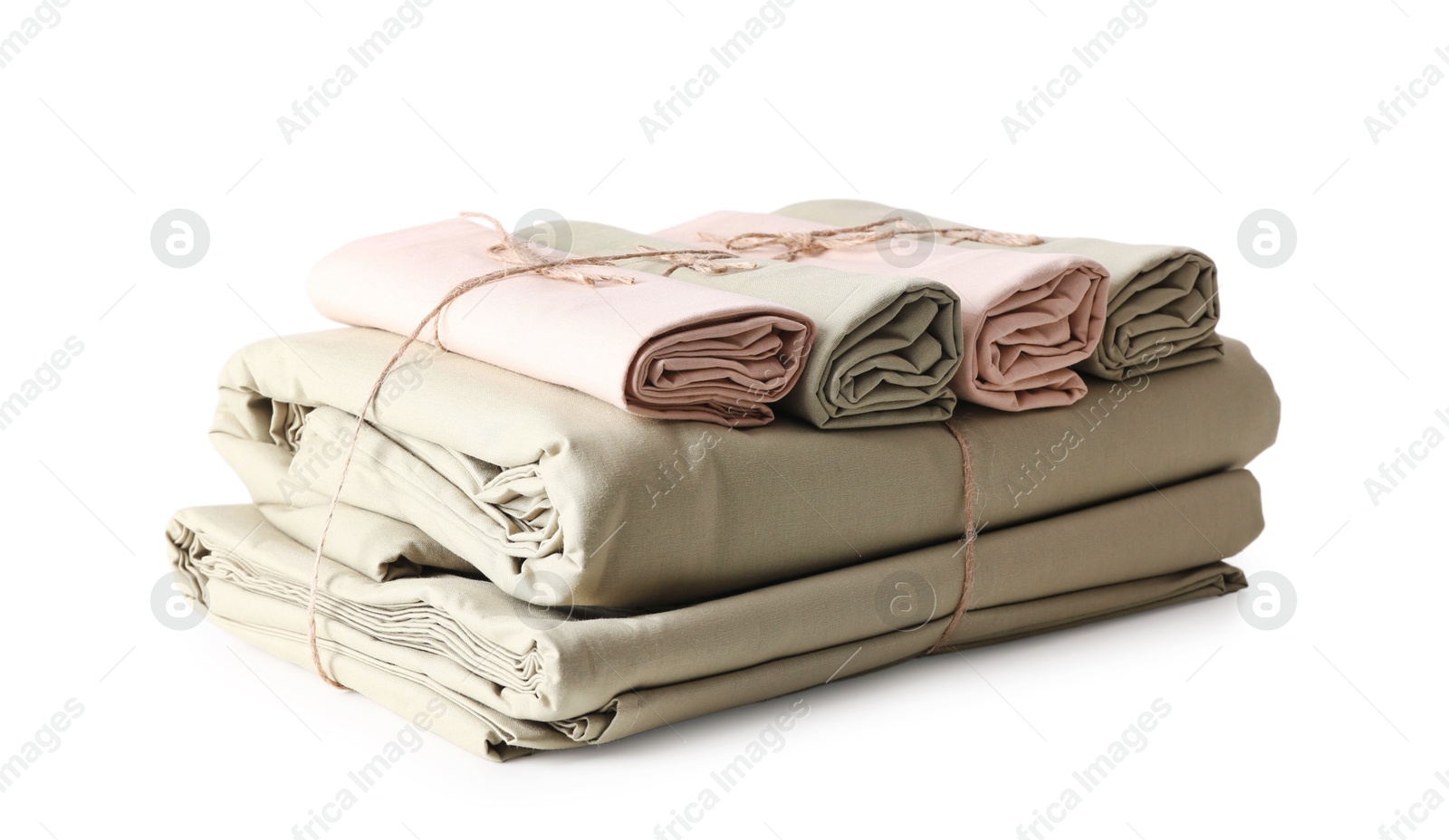 Photo of Stack of clean bed sheets tied with rope isolated on white