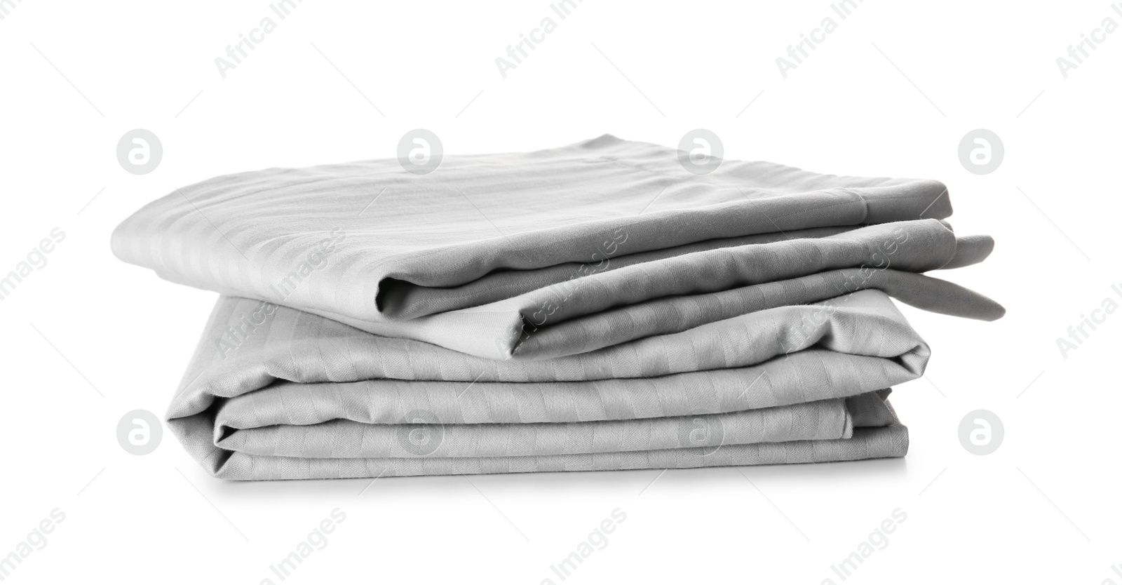 Photo of Stack of clean bed sheets isolated on white