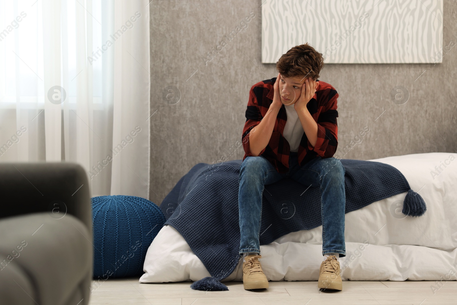 Photo of Loneliness concept. Sad teenage boy on bed at home