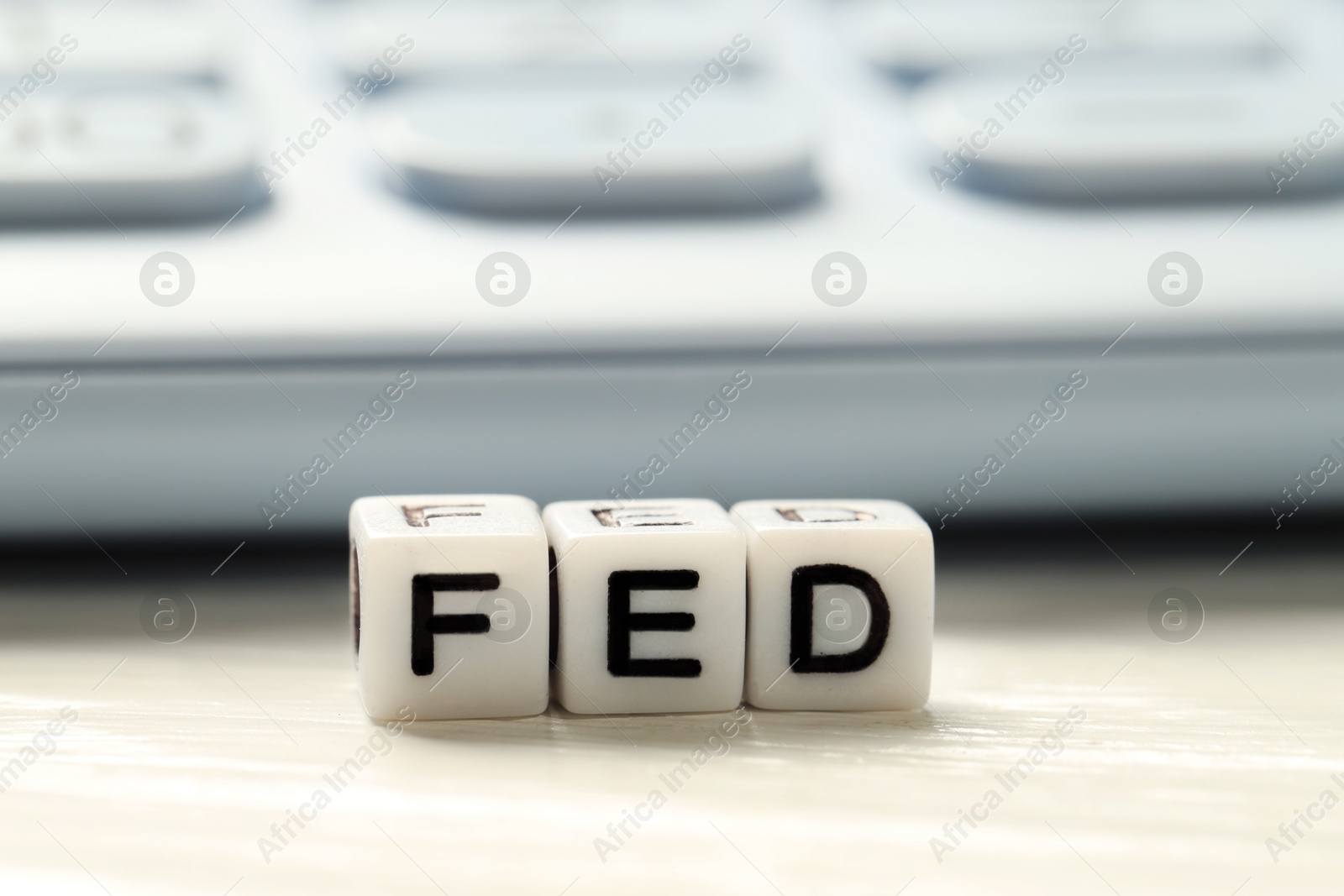 Photo of Cubes with letters Fed (Federal Reserve System) on white table, closeup