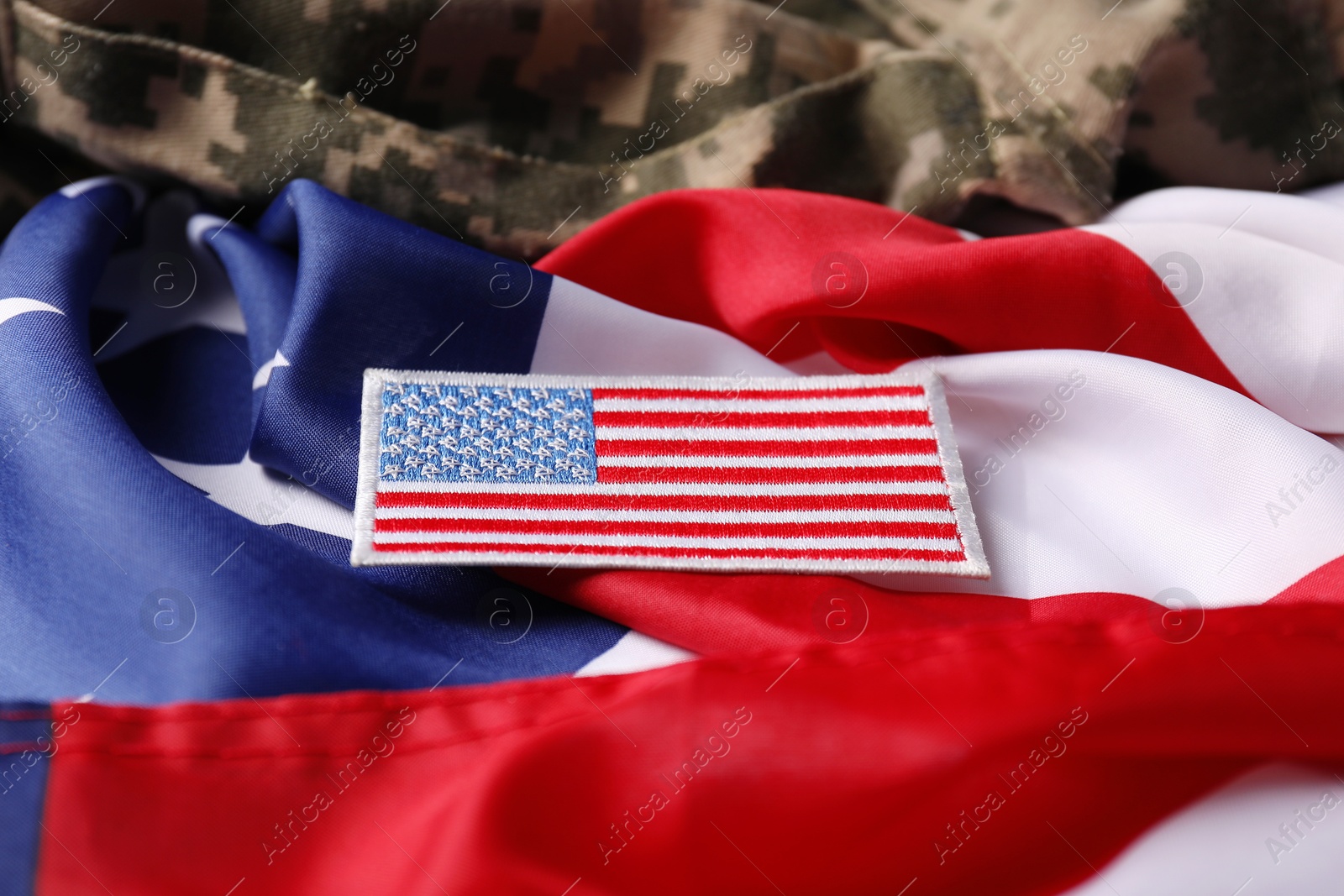 Photo of Veterans day. USA flag and army patch on military uniform, closeup