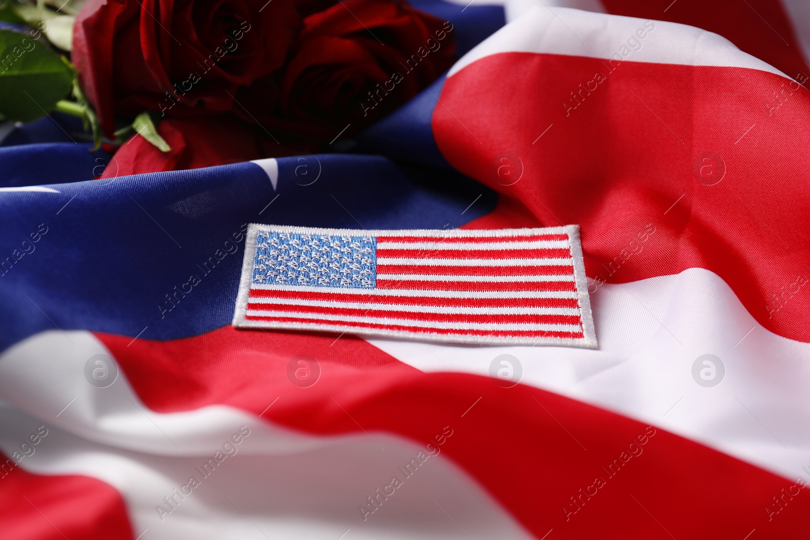 Photo of Veterans day. USA army patch on American flag, closeup