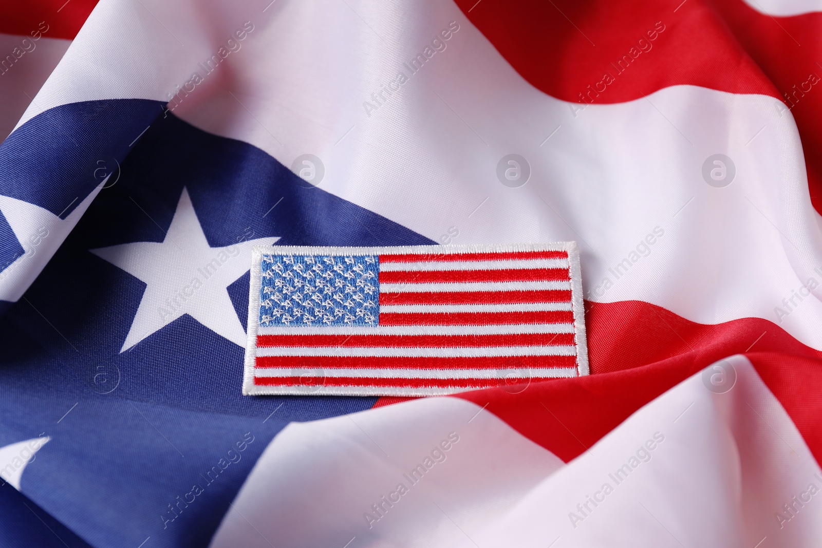 Photo of Veterans day. USA army patch on American flag