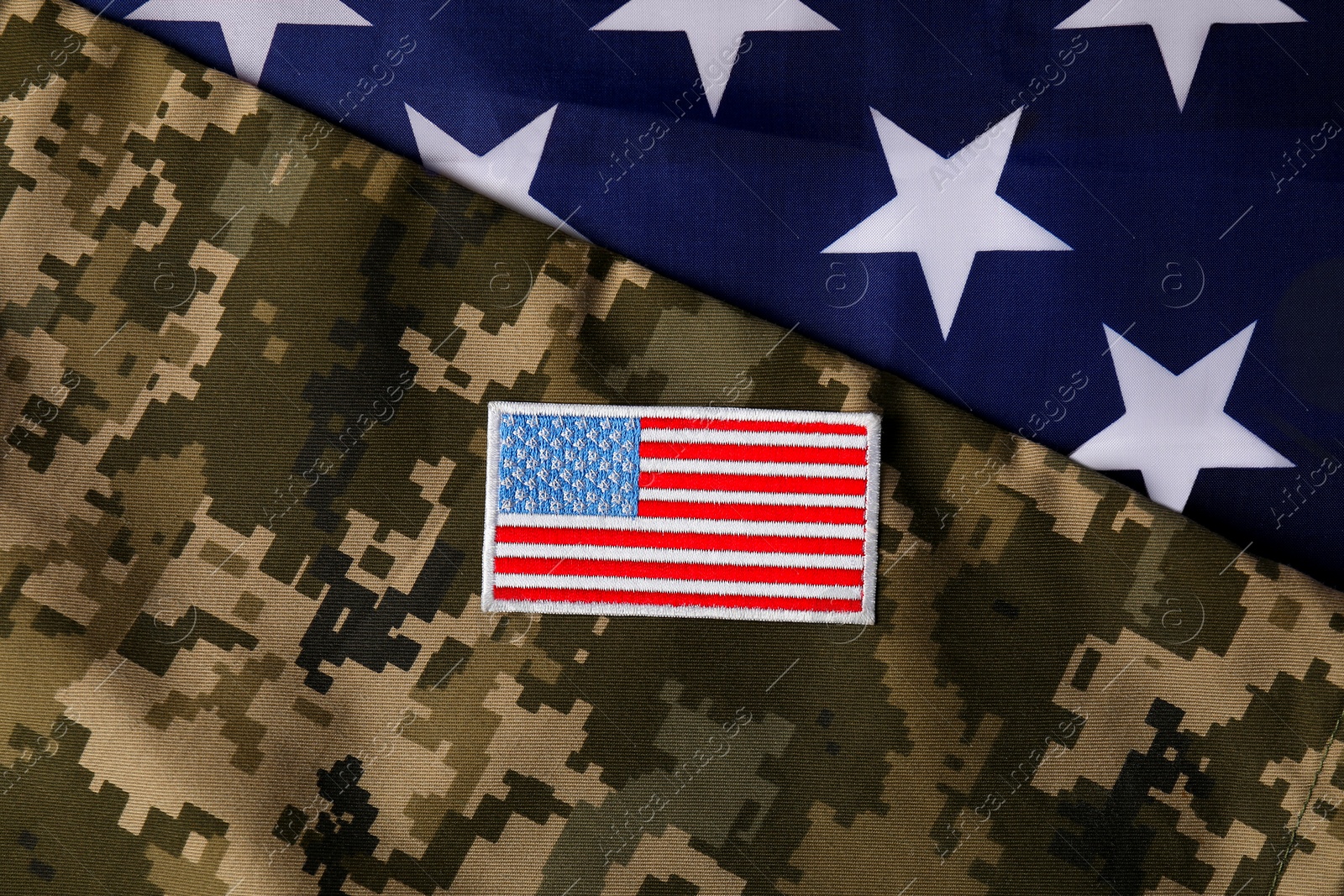 Photo of Veterans day. USA army patch and military uniform on American flag, flat lay