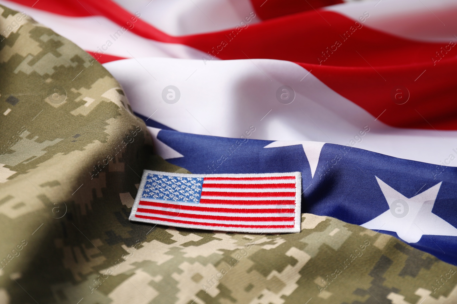 Photo of Veterans day. USA army patch and military uniform on American flag