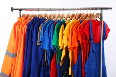 Photo of Different workers' uniforms on white background, closeup