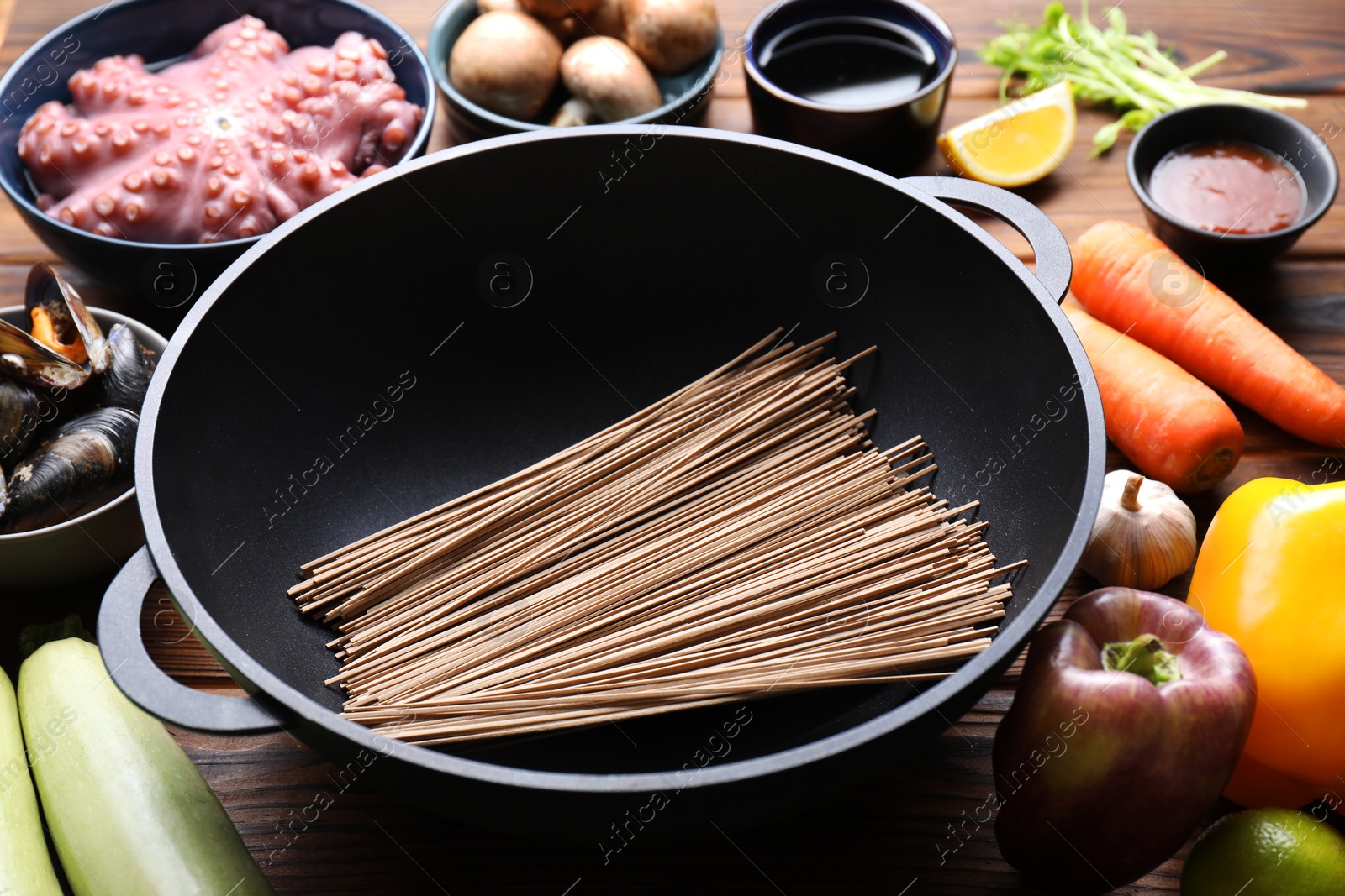 Photo of Different ingredients for wok on wooden table