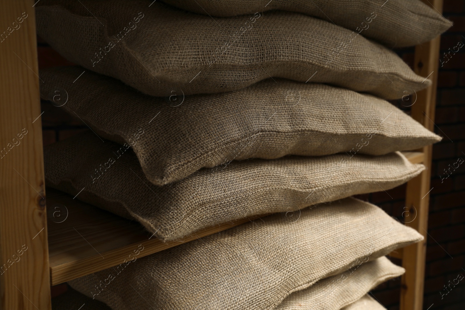 Photo of Group of burlap sacks on shelving unit, closeup