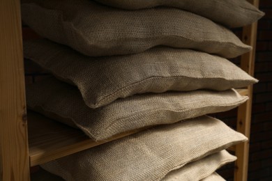 Photo of Group of burlap sacks on shelving unit, closeup