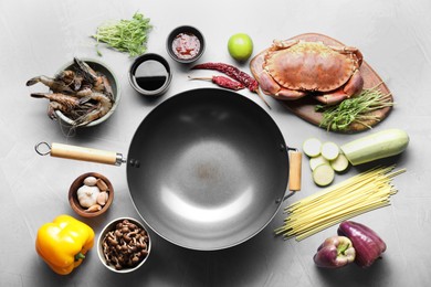 Different ingredients for wok on light grey table, flat lay