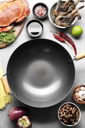 Different ingredients for wok on light grey table, flat lay