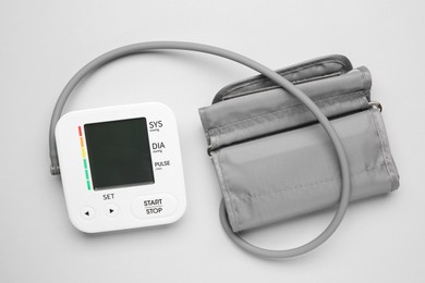 Photo of Blood pressure measuring device on light grey background, top view