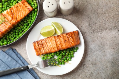 Photo of Delicious grilled salmon fillet served on grey textured table, flat lay