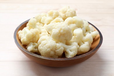 Photo of Tasty cooked cauliflower on white wooden table, closeup