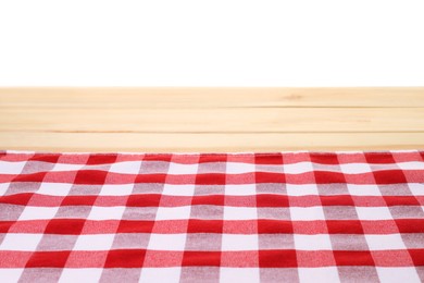 Tablecloth with checkered pattern on light wooden table against white background