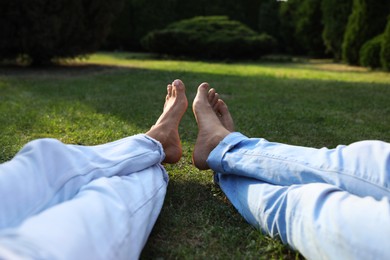 Photo of Couple spending time together on green lawn in park, closeup