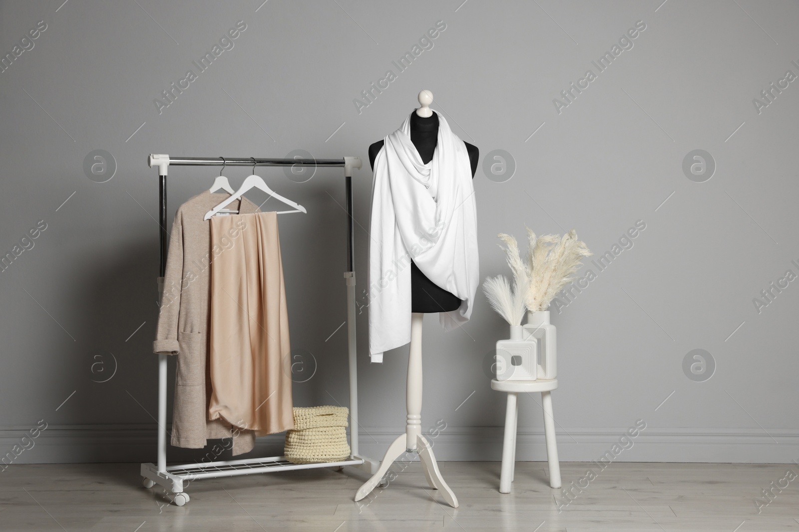 Photo of Female mannequin with white scarf and other clothes indoors