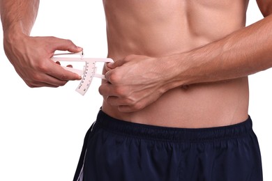 Photo of Man measuring body fat with caliper on white background, closeup