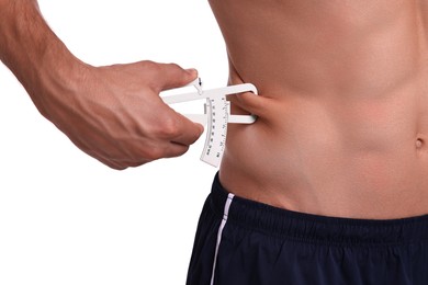 Photo of Man measuring body fat with caliper on white background, closeup